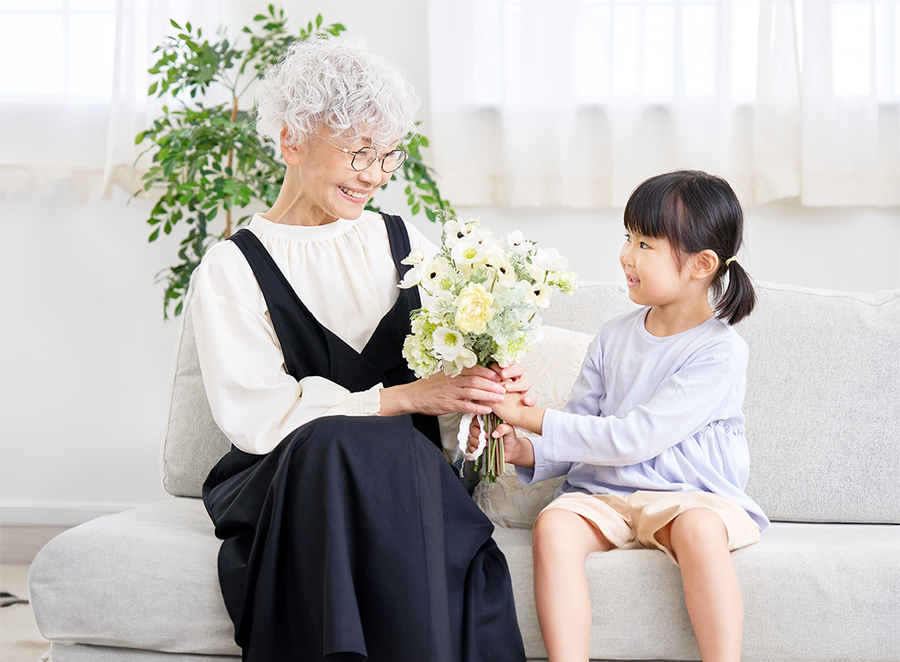 おばあちゃんに花を贈る少女